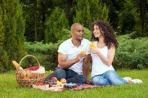 Happy young couple spending time together in park photo