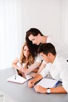 beautiful woman young private teacher helping two students doing homework