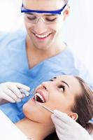 Male dentist with female patient photo