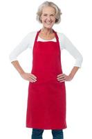 Cheerful aged confident female chef photo