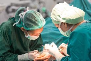 young female surgeon doing operation photo