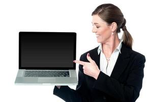 Female sales executive presenting new laptop photo