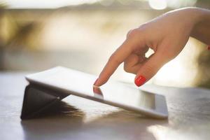 female hand clicks on a digital tablet