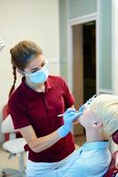Dentist curing a female patient photo