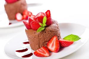 Chocolate mousse with strawberries on white plate photo