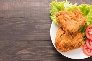 Fried chicken breast on a wooden background photo