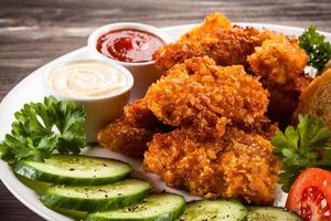 Chicken nuggets and vegetables photo