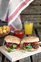 Homemade hamburgers with tomatoes, onions and pickles
