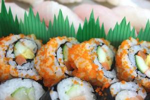 Close up the chopsticks with japanese sushi. photo