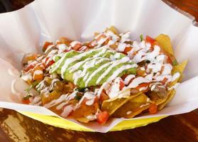 Beef Nacho with cheeses, salsa, guacamole and sour cream