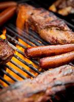 hot dogs and ribs on a grill photo