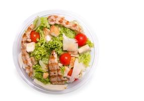 Caesar salad with grilled chicken meat, top view photo