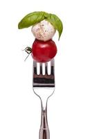 Basil, Mozzarella and tomato on a fork photo