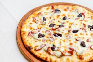 pizza on wooden plate photo