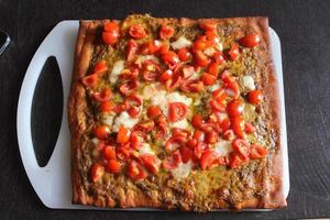 Italian Homemade Pesto and Tomatoes Pizza.