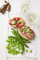 Italian snacks. salami sandwich with parmesan cheese & broad bea photo
