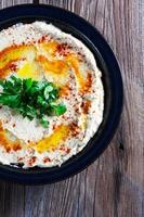 Fresh hummus with parsley and oil. photo
