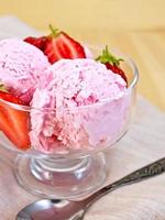 Ice cream strawberry in glass goblet on napkin