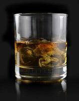 whiskey with ice in a glass photo
