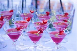 Line of different alcohol cocktails on event open-air night party