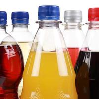 Bottles with soda drinks like cola and orange lemonade