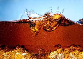 Cola with Ice. Splash and bubbles photo