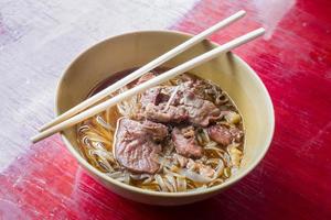 Asian noodle with stewed pork in the bowl photo