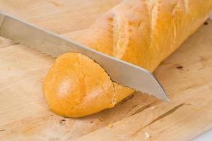 Knife cuts French baguette