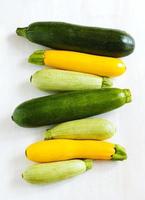 Fresh zucchini on the wooden background