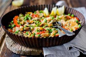 Paella with mussels and green peas photo