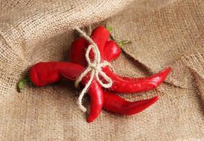 Red hot chili peppers on sackcloth, background photo