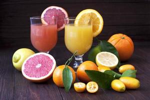 Fresh fruit juices on wooden table photo