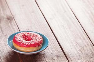 Donut on wooden table. photo