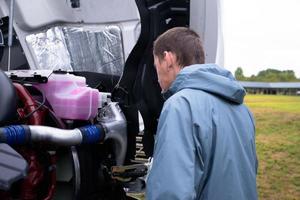 Truck driver check semi truck engine before driving semi truck