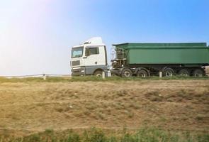 dump truck goes on the country highway photo