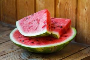 Juicy big red watermelon lying on a wooden table