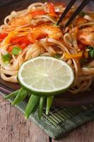 delicious rice noodles with shrimp and vegetables vertical