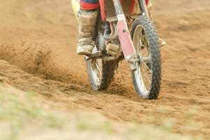 motocross racer accelerating speed in track photo