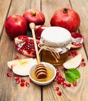 Honey with pomegranate and apples photo