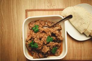 Lamb mutton Korma on a wooden background photo