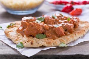 Butter Chicken Curry Served on Naan photo