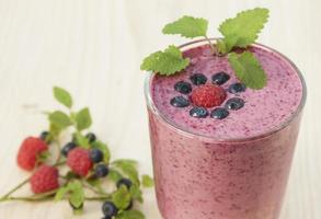 Cocktail of blueberries, raspberries and lemon balm with yogurt photo