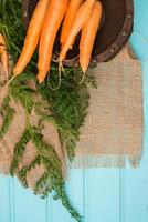 Carrots on a wooden table photo