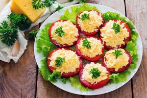 Snack cheese salad on slices of tomato photo