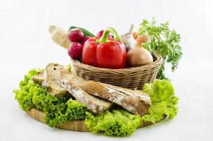 Composition with bread and vegetables on wooden board. photo