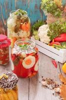 Assorted mixed vegetables in preserving jars photo