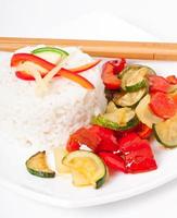 Plate of vegetable fried rice and chopstick. photo