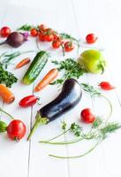 Raw eggplant with vegetables on table, selective focus photo