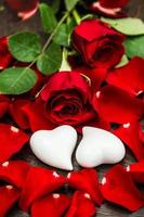 Red roses and two white hearts. Valentines Day or Wedding