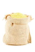 Sack is linen filled by yellow millet photo